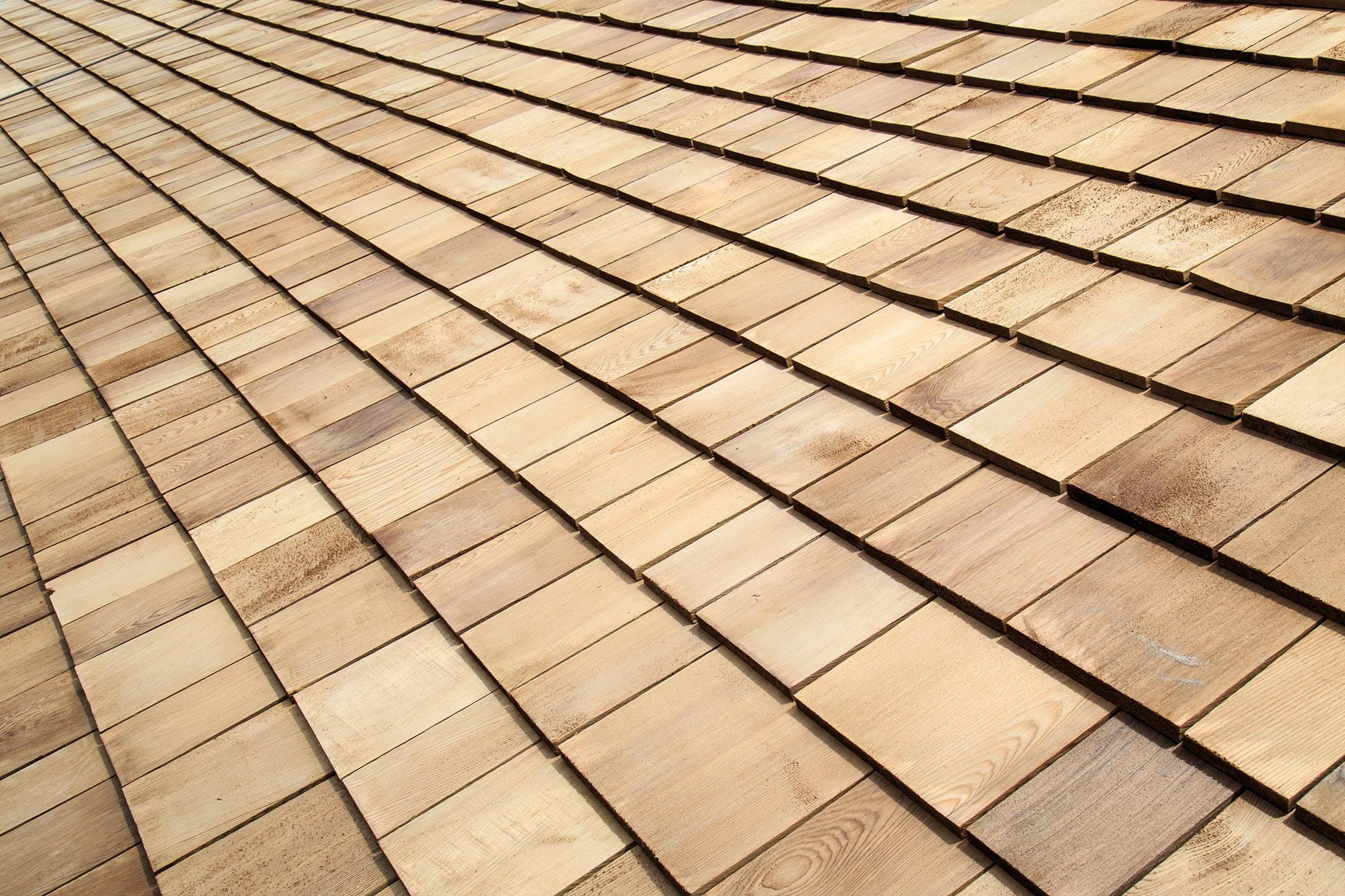 A detail shot showing the texture and layering of wood shake roofing